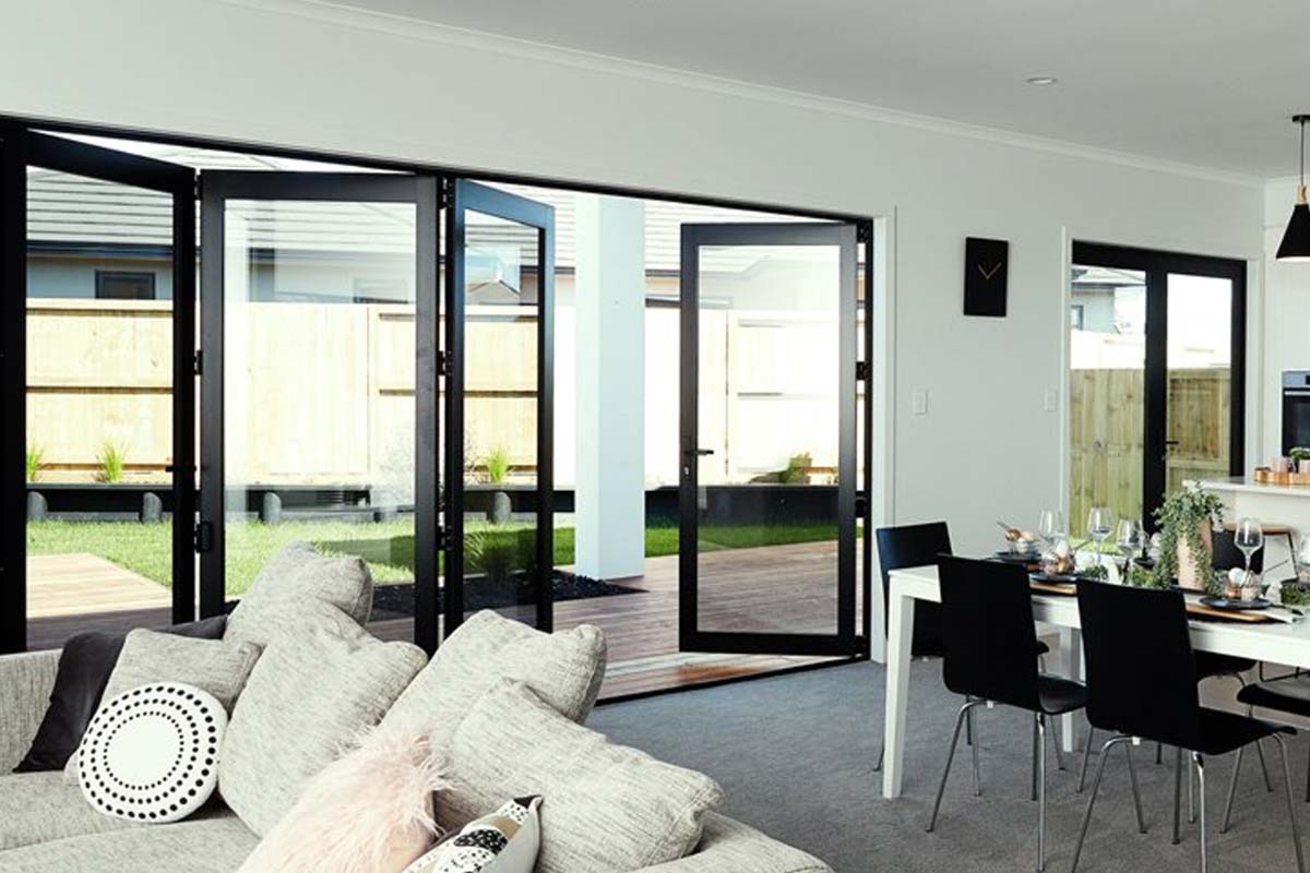 Stunning bi-fold aluminium doors fully opened creating seamless indoor-outdoor living space