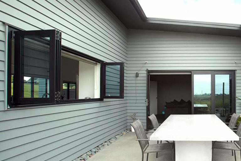 Bi-folding aluminium windows creating expansive openings with panoramic garden views